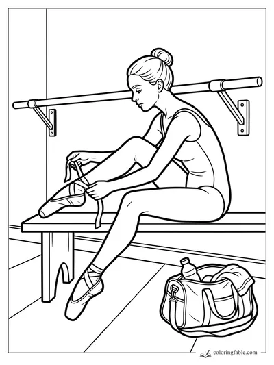 Ballerina tying pointe shoe ribbons on a bench beside a barre and dance bag